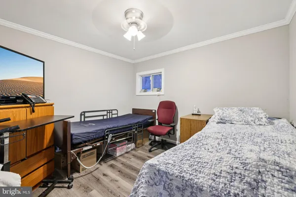 a bedroom with bed and a chandelier