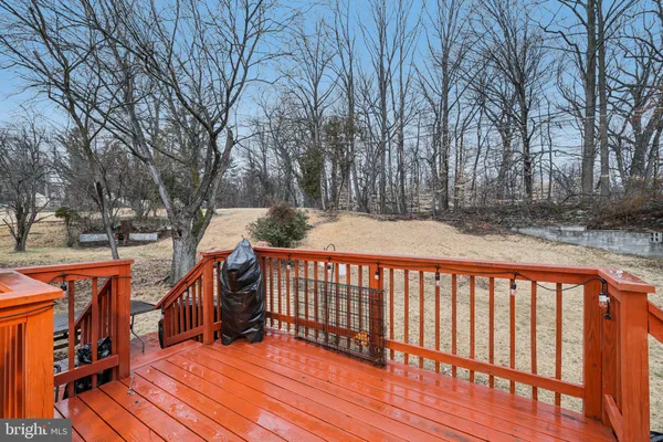 a balcony with wooden floor and trees