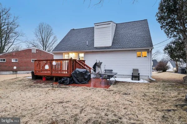 a backyard of a house with fire pit and couches