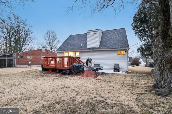 a view of a house with a yard and sitting area