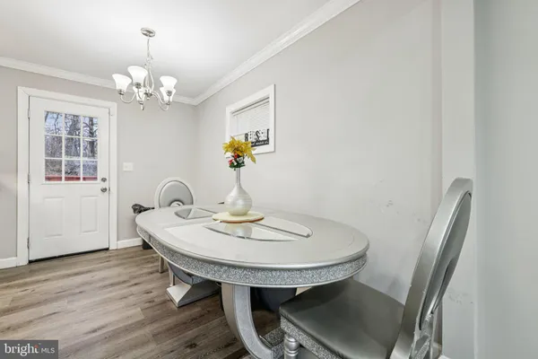 a view of a dining room with furniture and chandelier