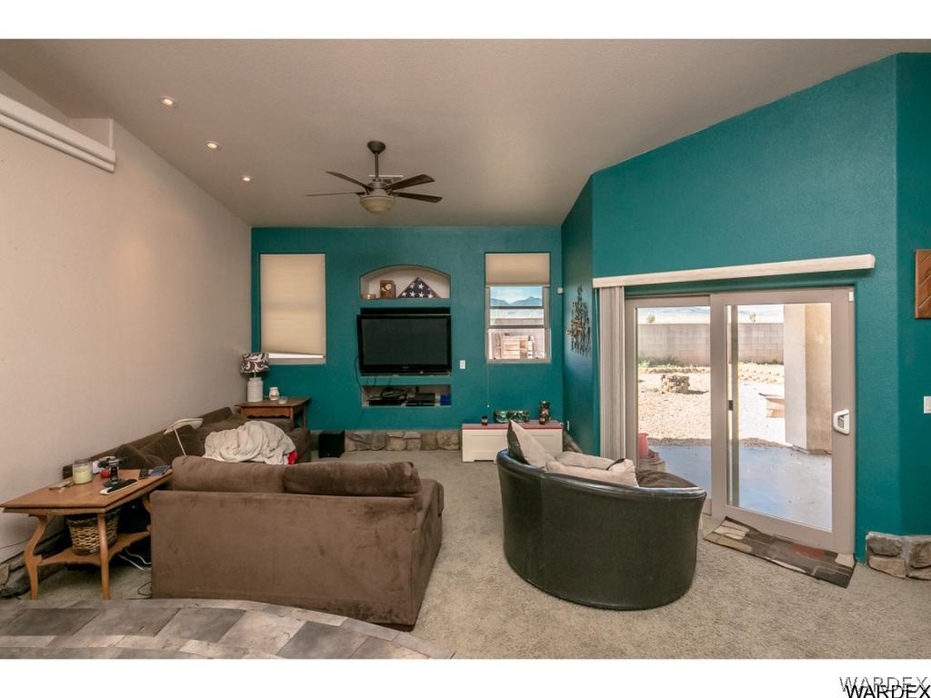 4951 North Neal Ranch Road Kingman, AZ 86401 - Photo 3 of 34 a living room with furniture and a flat screen tv