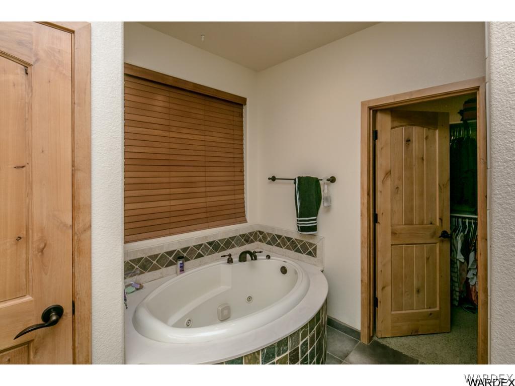 4951 North Neal Ranch Road Kingman, AZ 86401 - Photo 9 of 34 a bathroom with a sink and a mirror