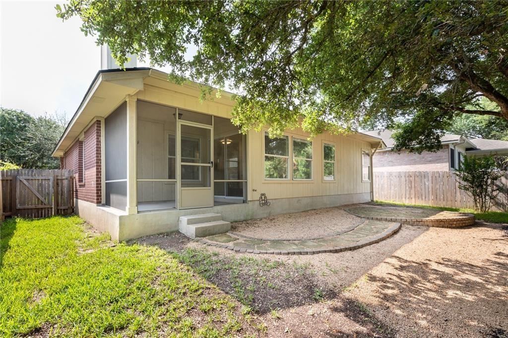 4526 Corran Ferry Loop Austin, TX 78749 - Photo 4 of 25 Mature trees shade a quiet backyard featuring a screened porch and curved stone pathways.