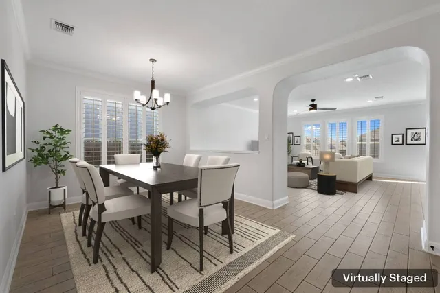 a view of a chandelier in big room and chandelier fan