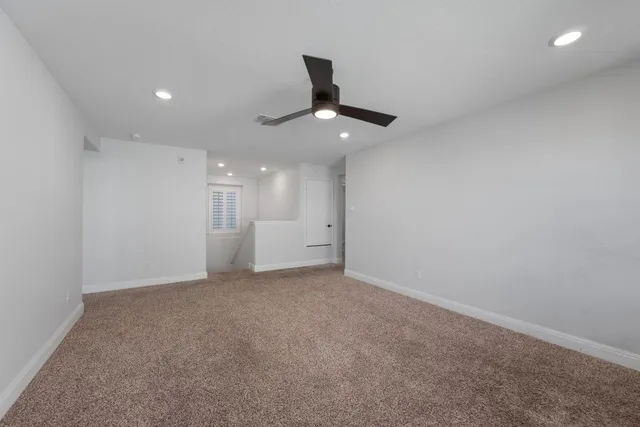 a bedroom with a large bed and a couch