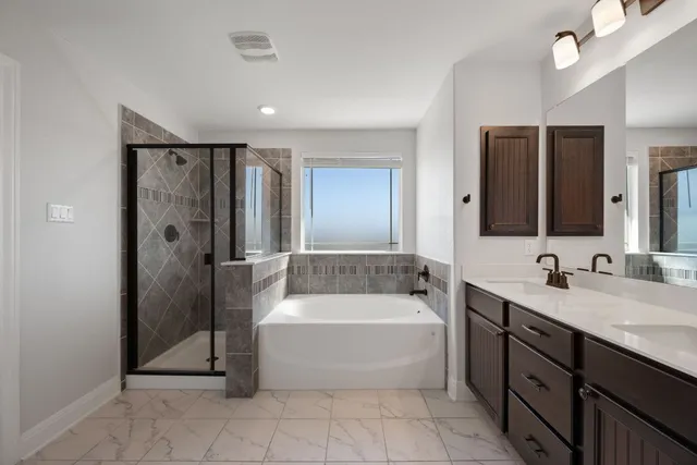 a spacious bathroom with a double vanity sink and mirror