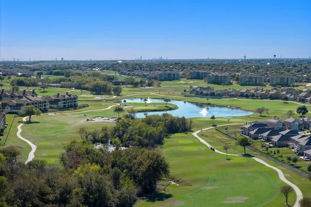 an aerial view of a residential houses with outdoor space