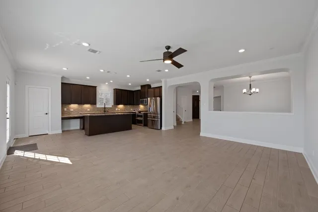 a view of a kitchen with a sink and a refrigerator