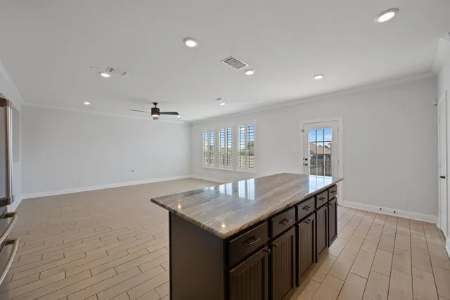 an empty room with wooden floor and entrance