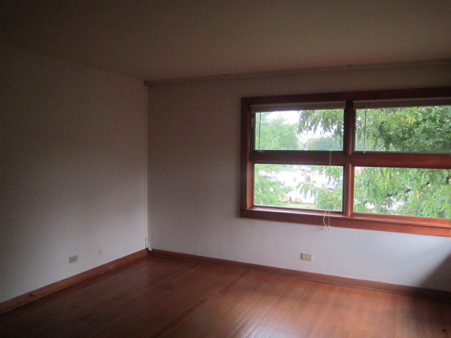 2926 Harlem Avenue Riverside, IL 60546 - Photo 11 of 20 an empty room with wooden floor and a window