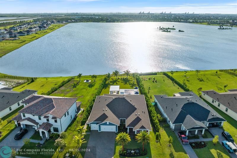 793 Hookline Circle Loxahatchee, FL 33470 - Photo 57 of 80 an aerial view of residential houses with outdoor space and lake view