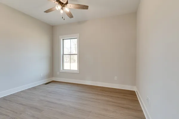 wooden floor in an empty room with a window