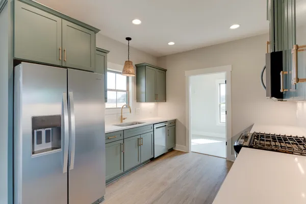 a kitchen with stainless steel appliances a refrigerator and a sink