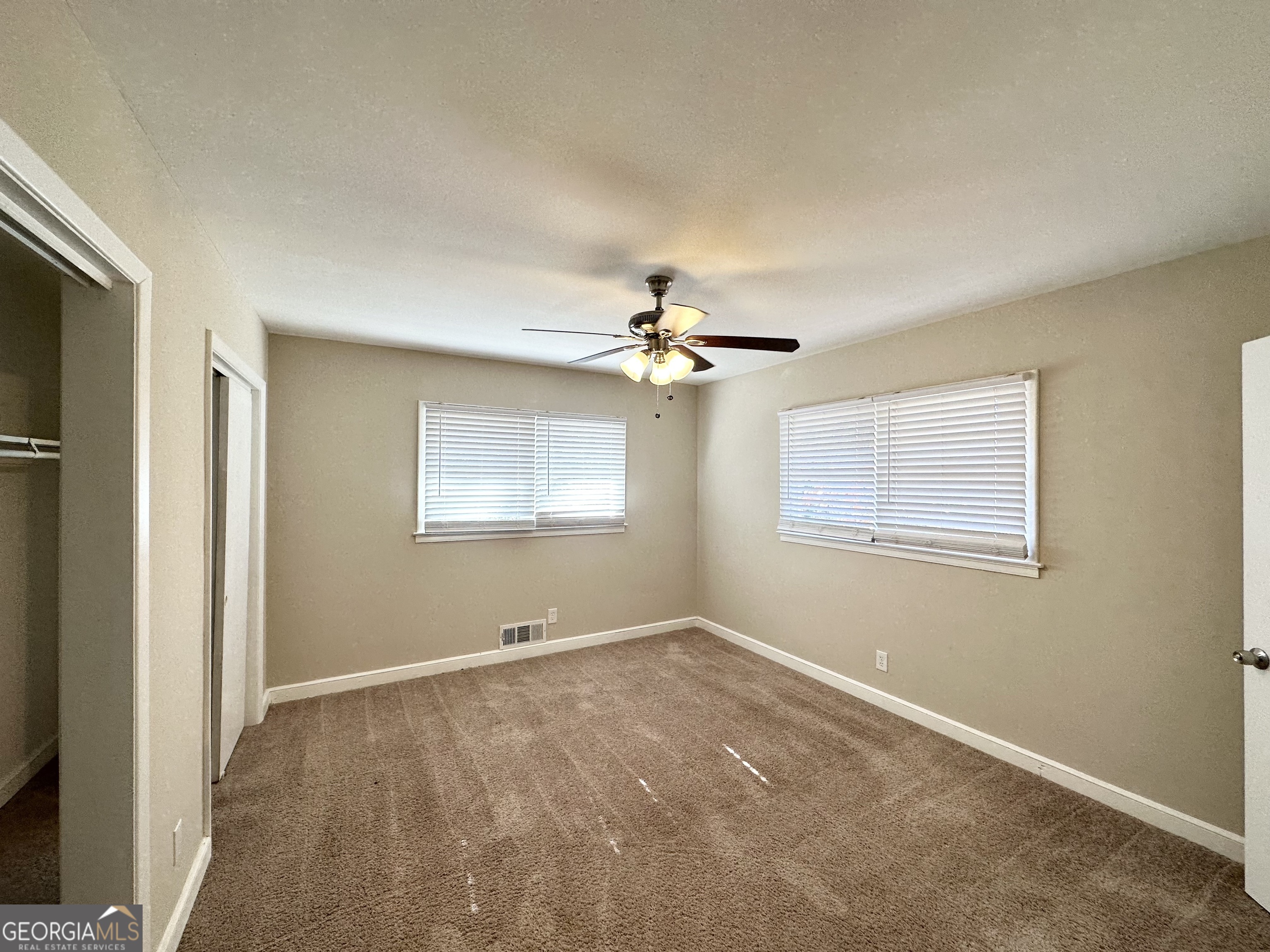 2896 Hogan Road East Point, GA 30344 - Photo 11 of 14 a view of a room with a ceiling fan and a window