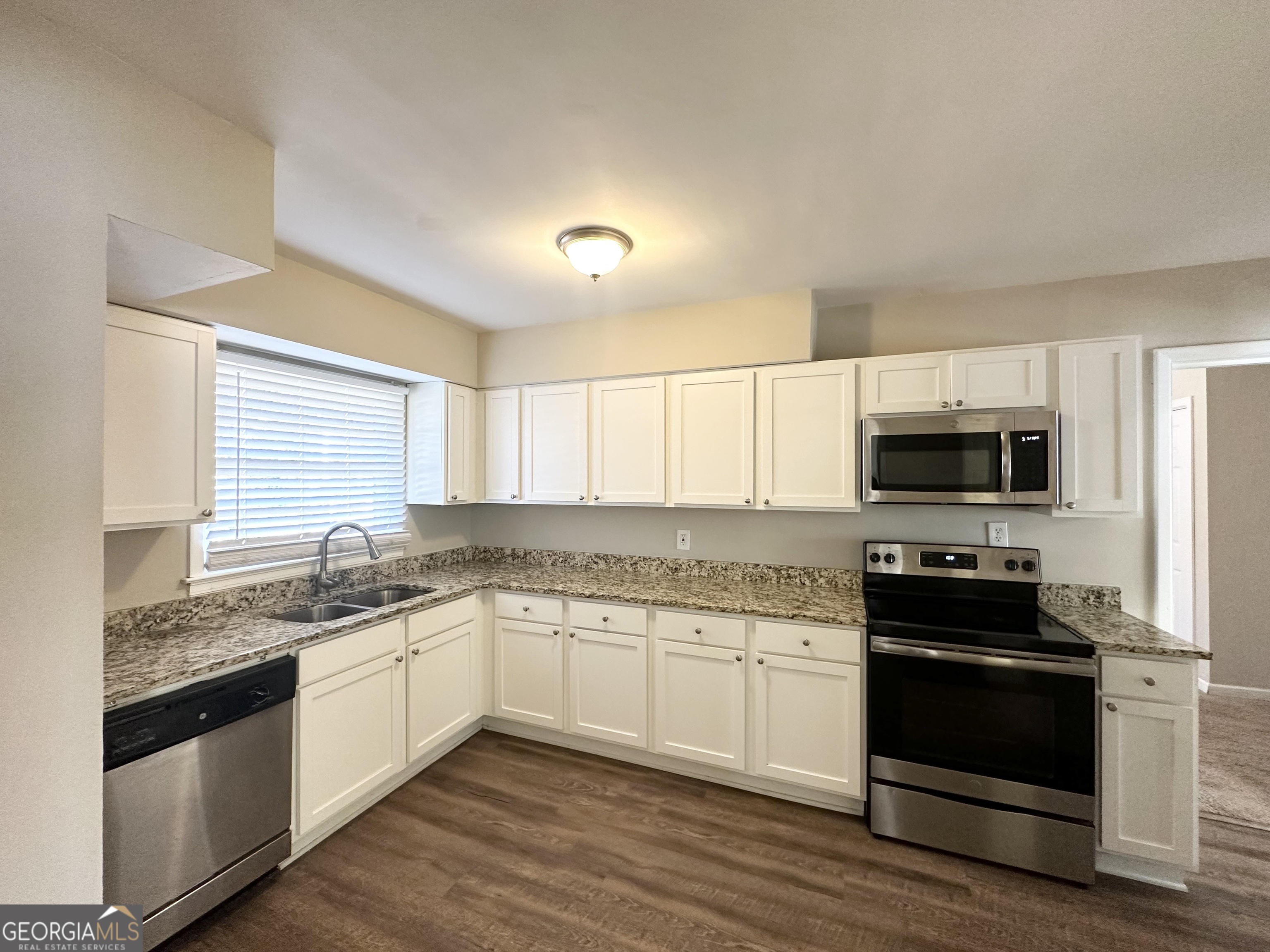 2896 Hogan Road East Point, GA 30344 - Photo 4 of 14 a kitchen with granite countertop a sink and steel appliances