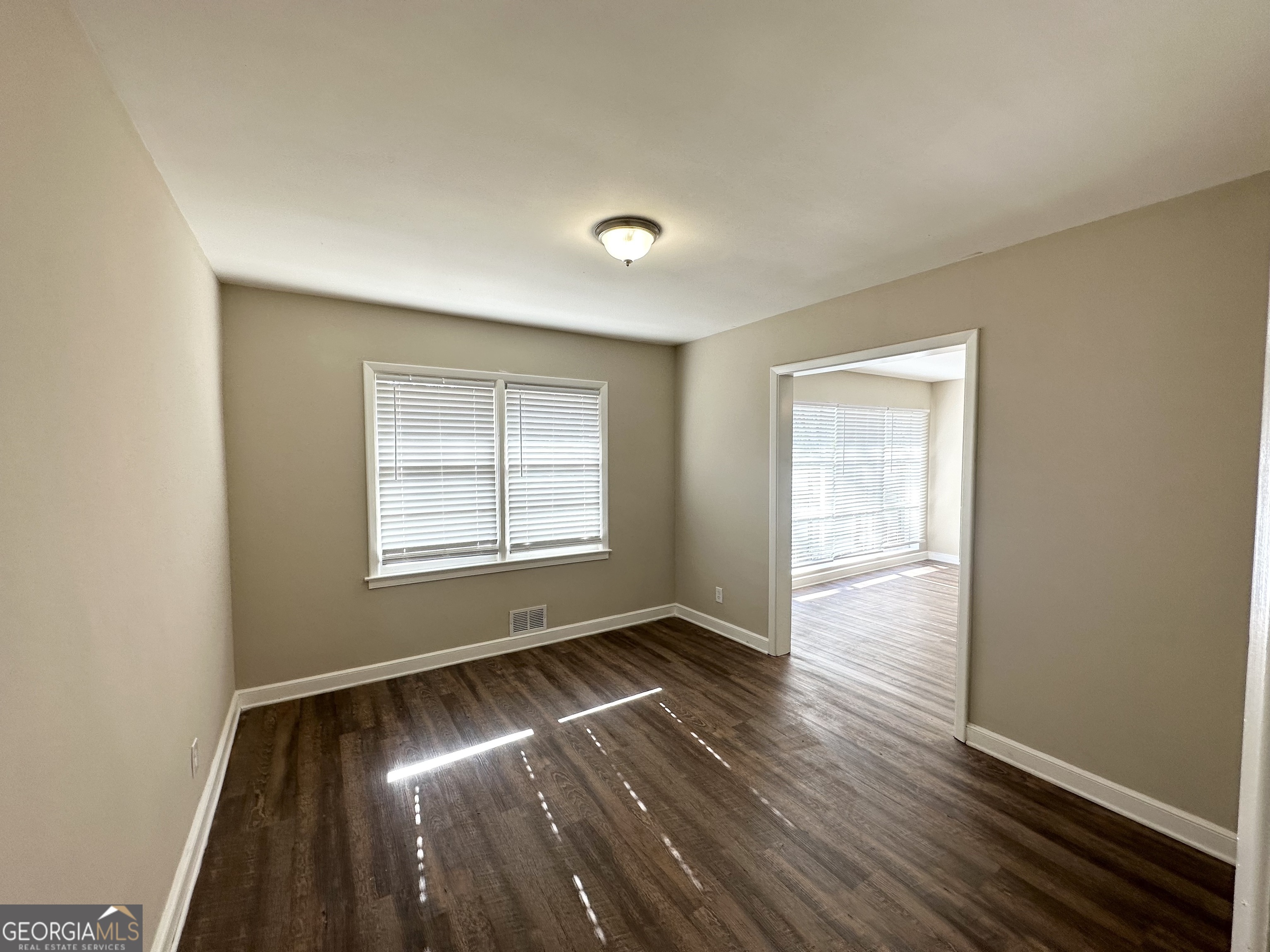 2896 Hogan Road East Point, GA 30344 - Photo 6 of 14 an empty room with wooden floor and windows