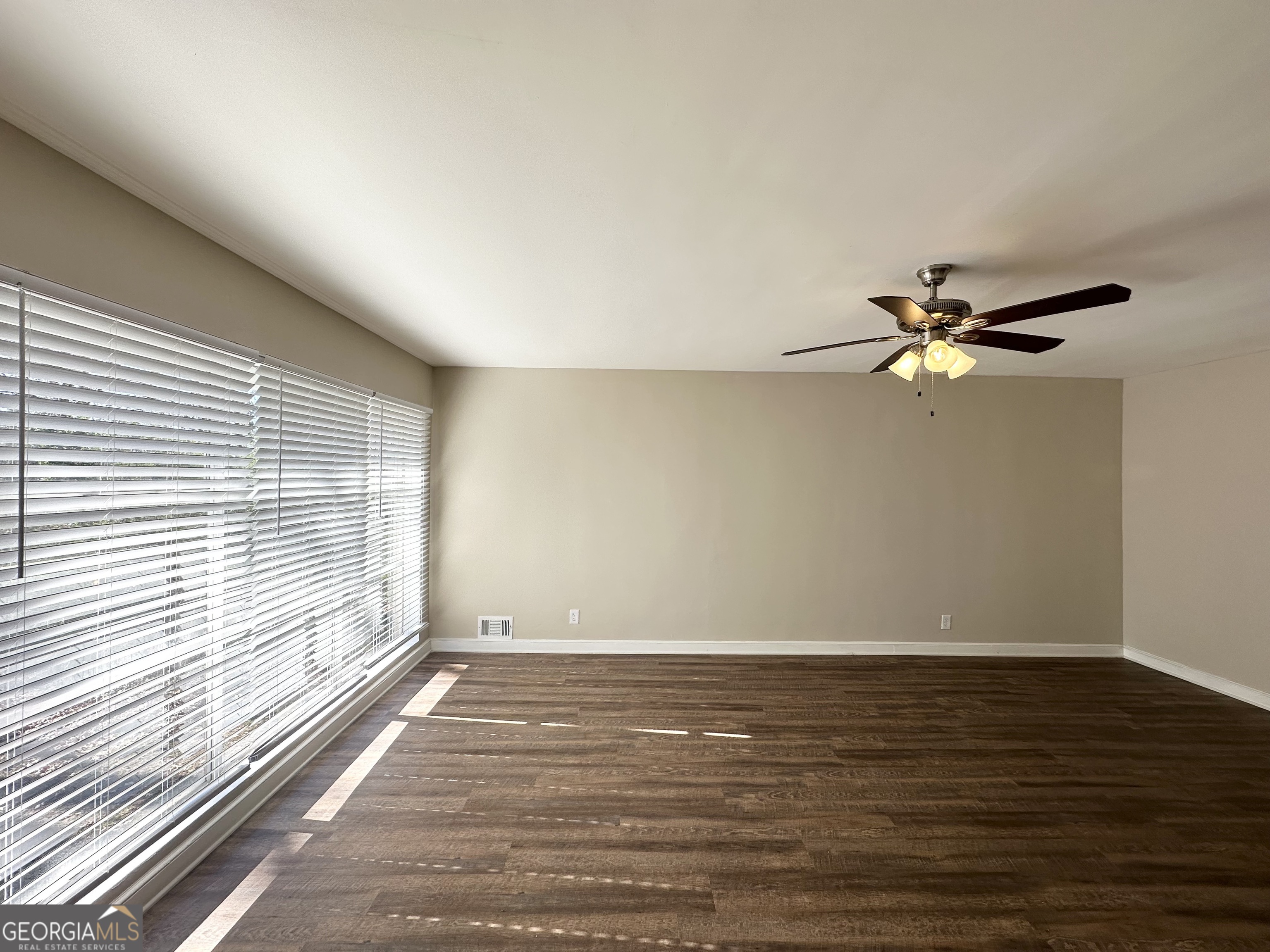 2896 Hogan Road East Point, GA 30344 - Photo 7 of 14 wooden floor in an empty room with a window