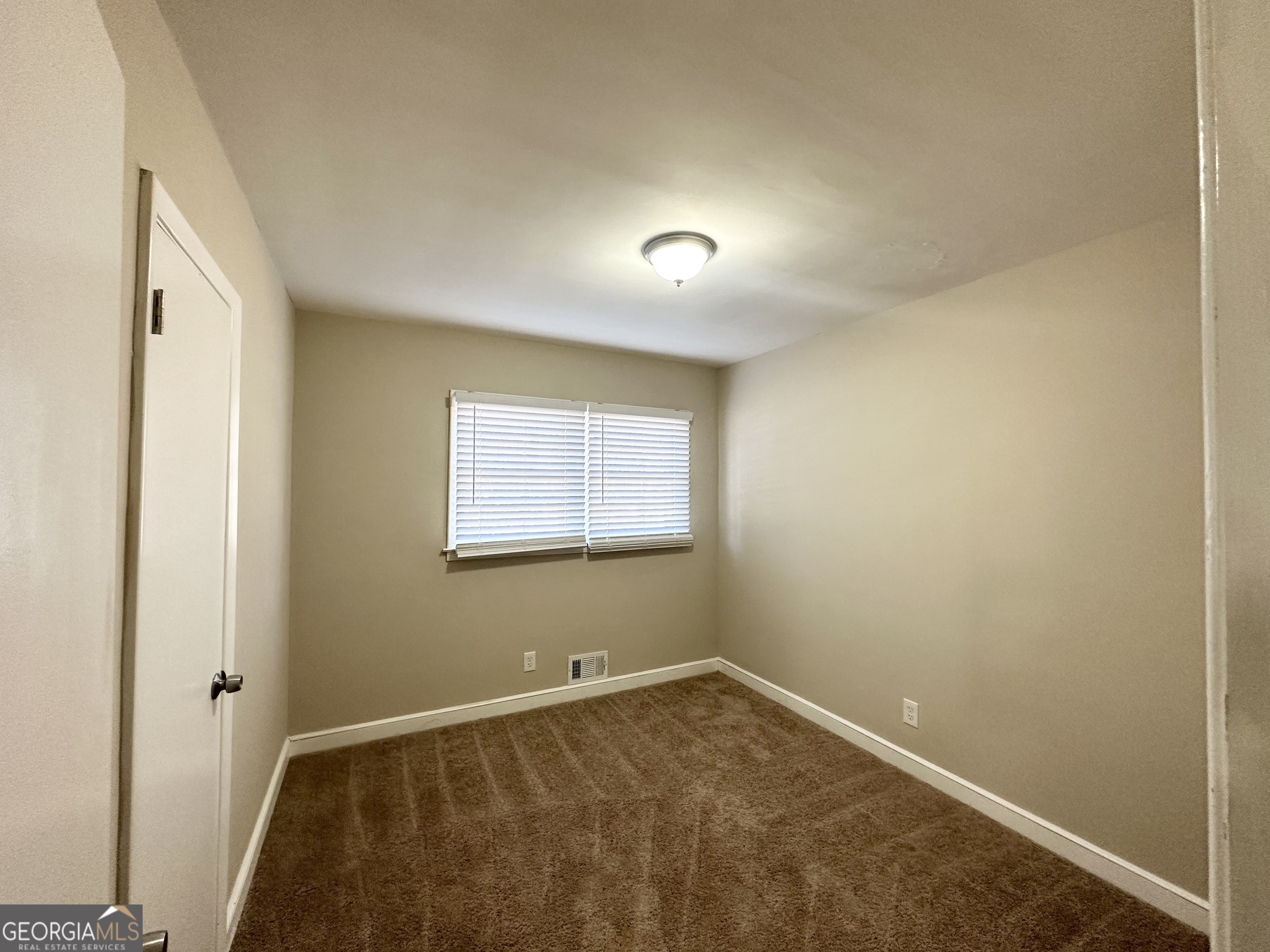 2896 Hogan Road East Point, GA 30344 - Photo 8 of 14 an empty room with a empty space and windows