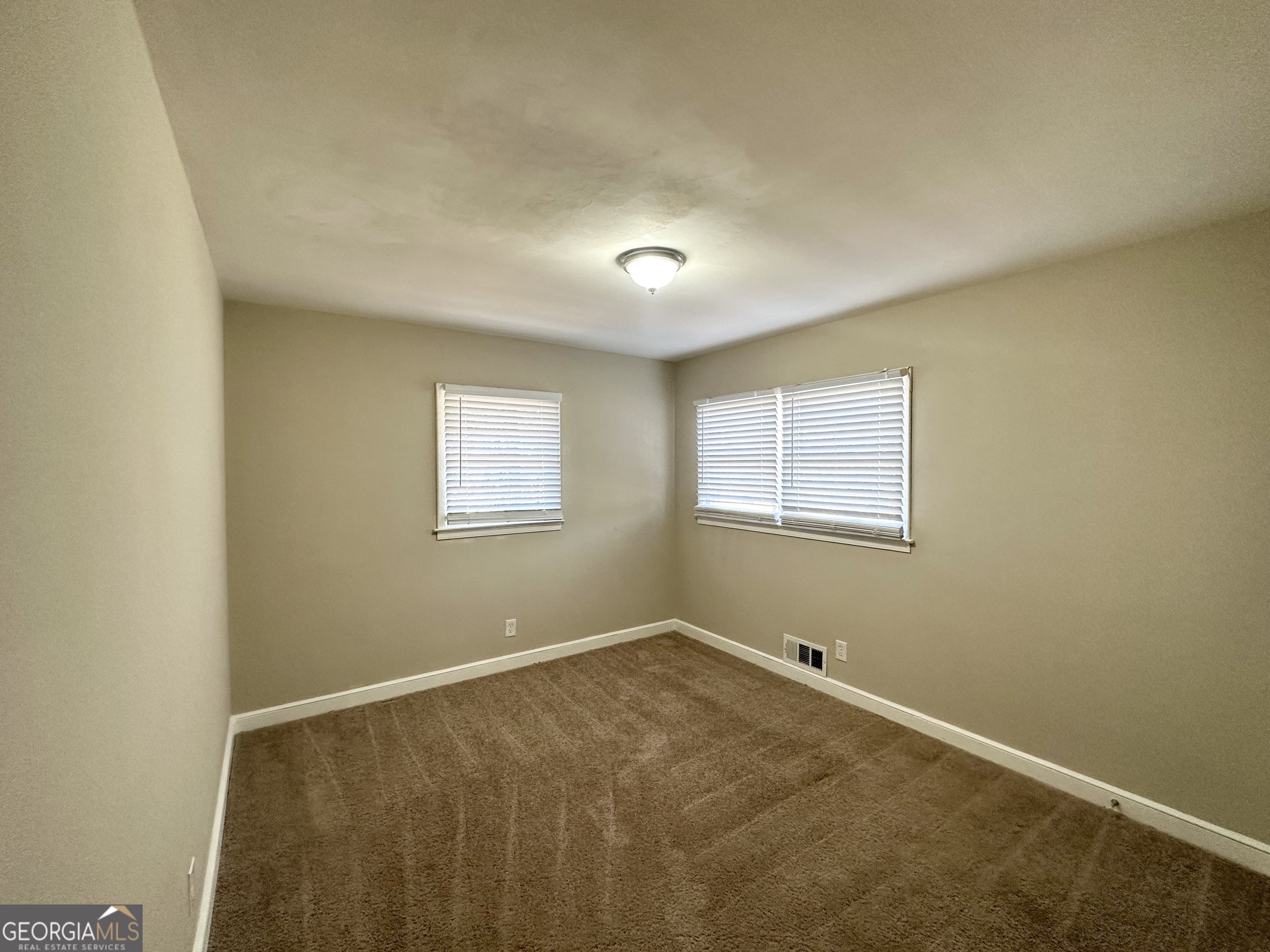 2896 Hogan Road East Point, GA 30344 - Photo 9 of 14 an empty room with a empty space and a window