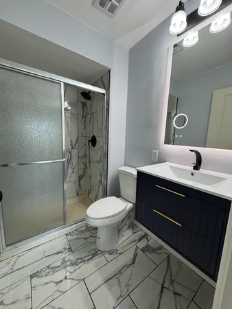 a bathroom with a sink toilet and shower