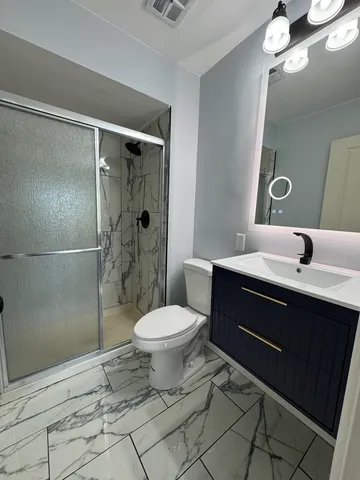 a bathroom with a sink toilet and shower