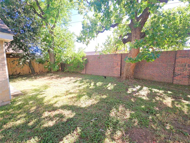 a backyard of a house with lots of green space