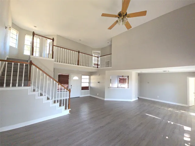 a view interior of a house with wooden floor and a ceiling fan