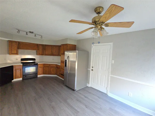 a kitchen with stainless steel appliances a refrigerator and a stove top oven