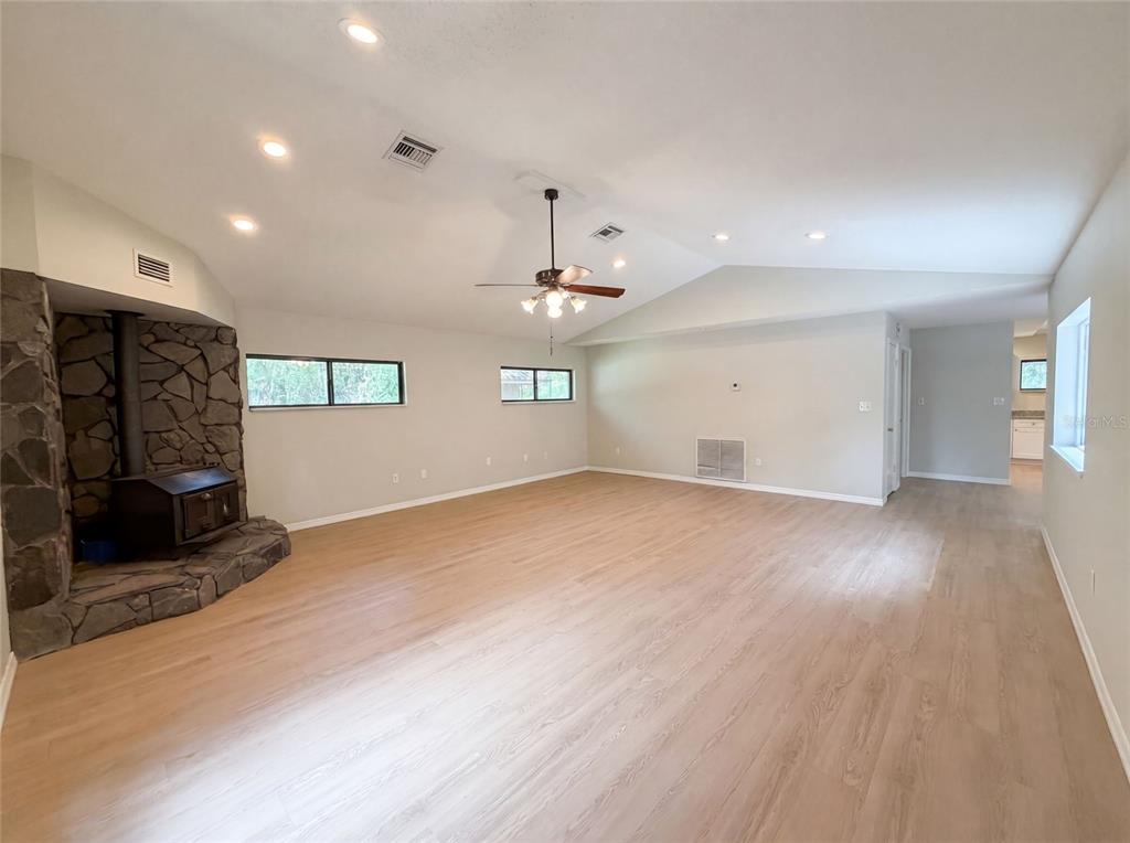 3739 Lake Griffin Road Lady Lake, FL 32159 - Photo 3 of 21 an empty room with fireplace and windows