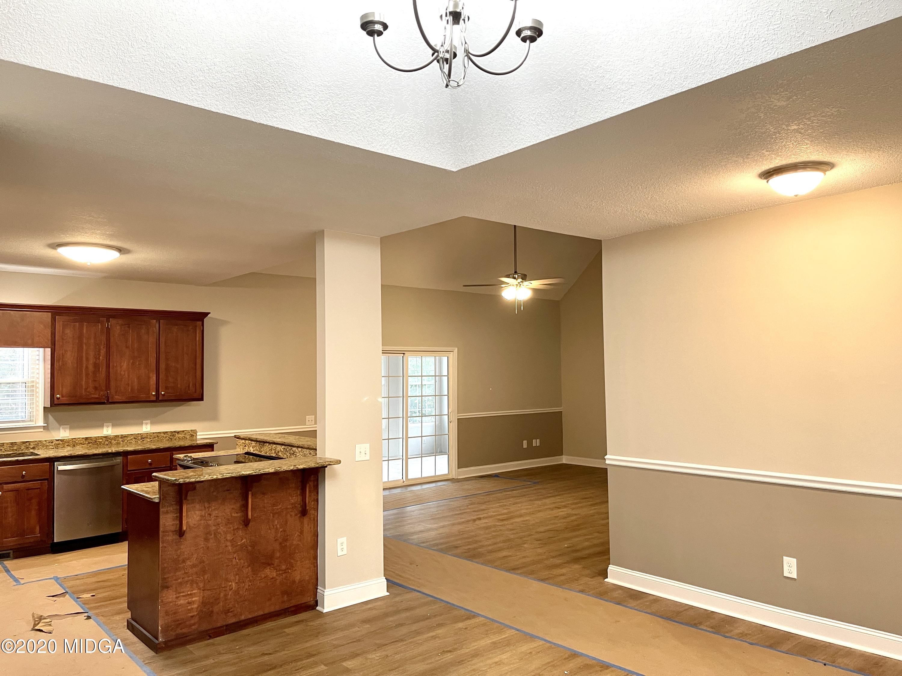 284 Klopfer Road Juliette, GA 31046 - Photo 2 of 15 a kitchen with granite countertop a stove and a refrigerator