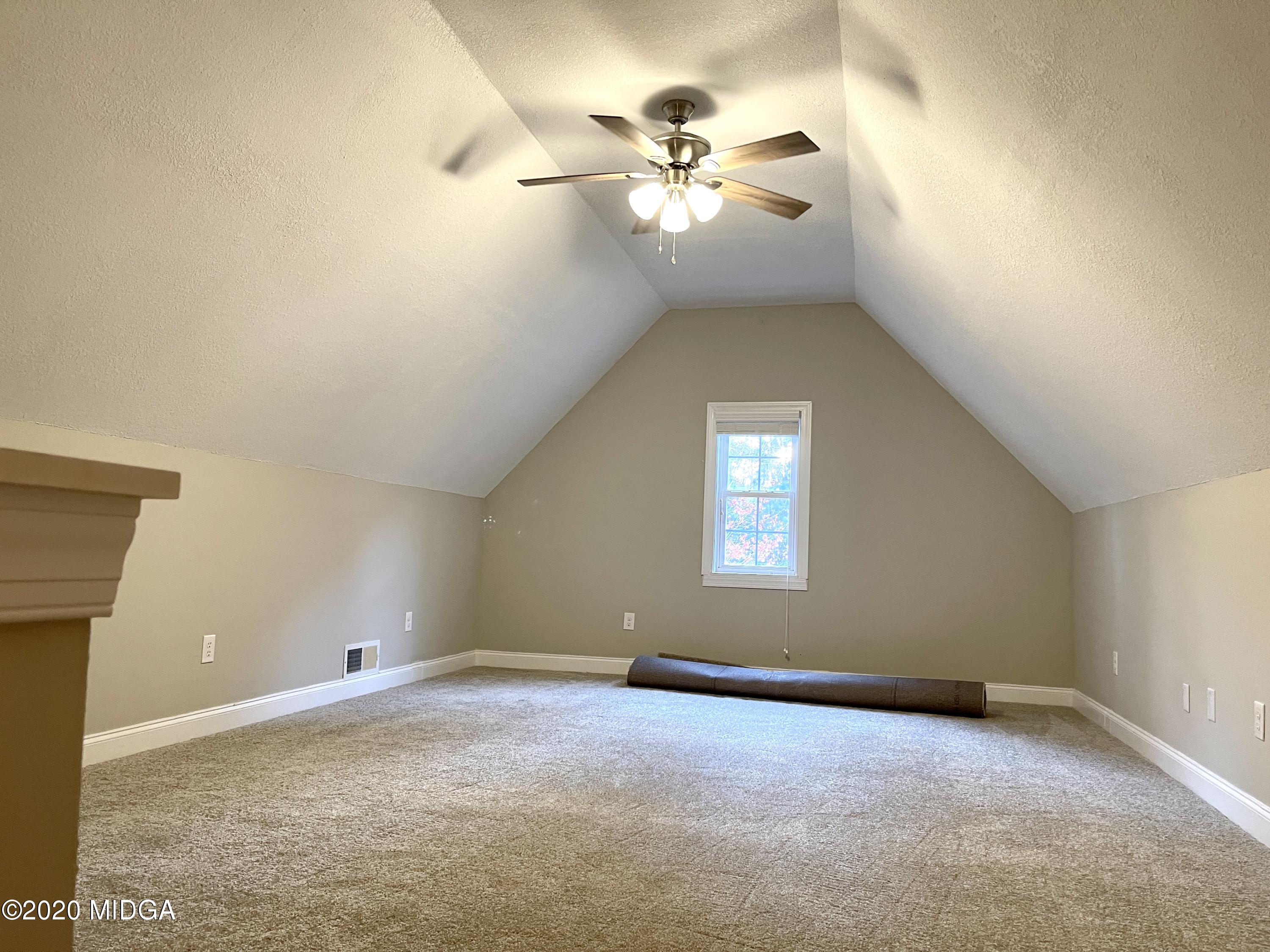 284 Klopfer Road Juliette, GA 31046 - Photo 15 of 15 an empty room with a chandelier fan and windows