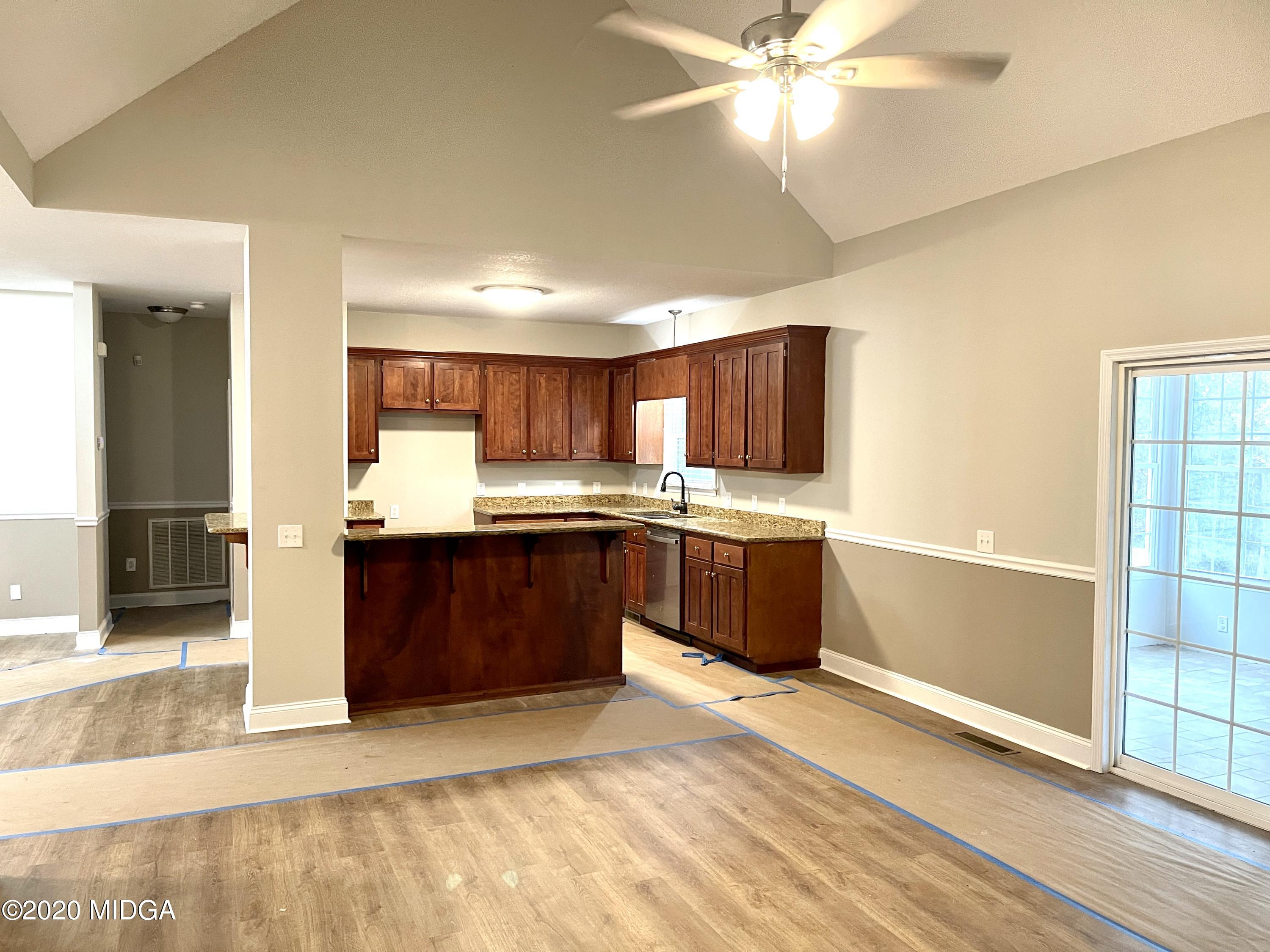 284 Klopfer Road Juliette, GA 31046 - Photo 4 of 15 a kitchen with stainless steel appliances kitchen island granite countertop a refrigerator a sink a stove a microwave and island
