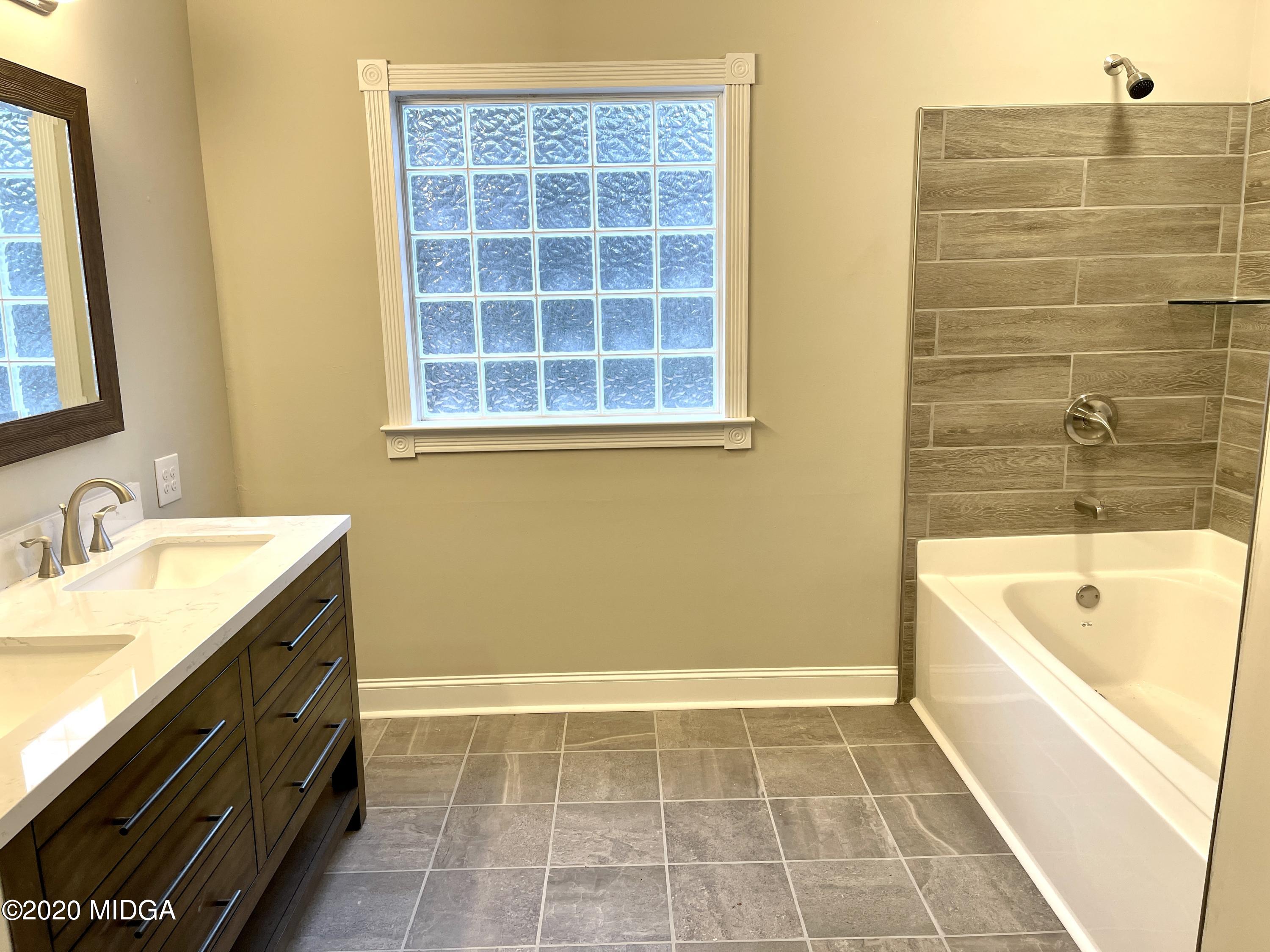284 Klopfer Road Juliette, GA 31046 - Photo 6 of 15 a bathroom with a tub sink and a mirror