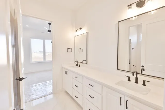 a bathroom with double vanity sink and mirror