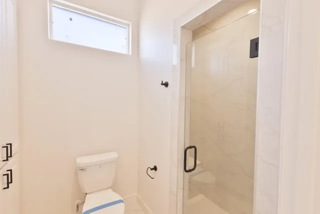 a bathroom with a toilet and shower