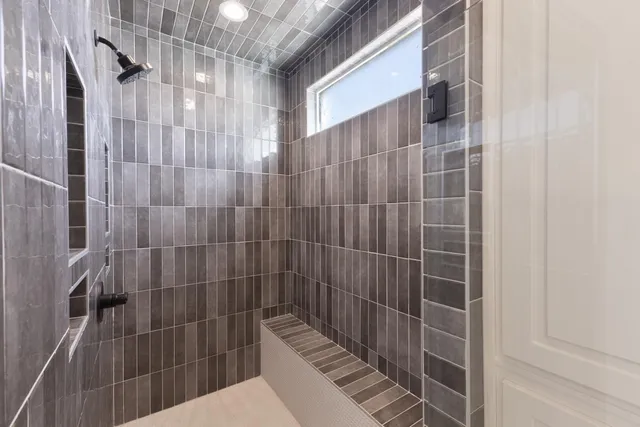 a bathroom with a bathtub and shower