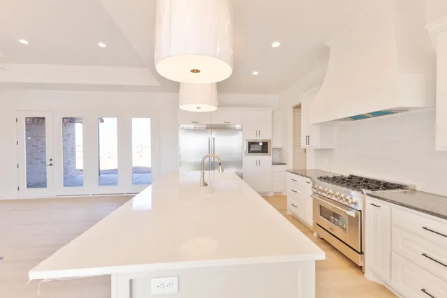 a large kitchen with a stove and a large window