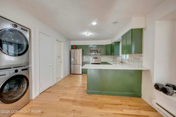 a view of a kitchen with washer and dryer