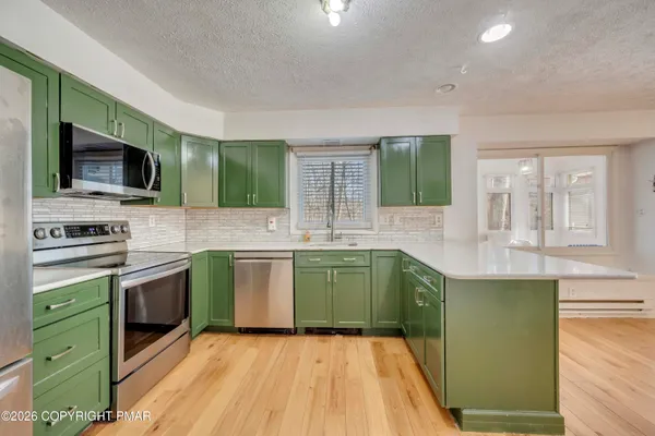 a kitchen with cabinets a sink and a microwave