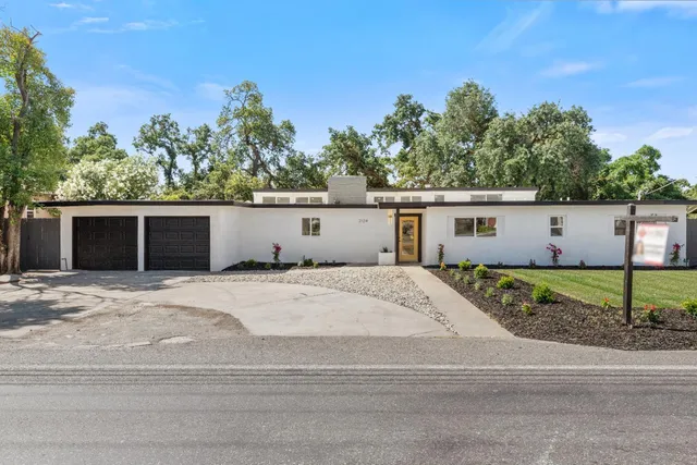 a view of a house with a yard and garage