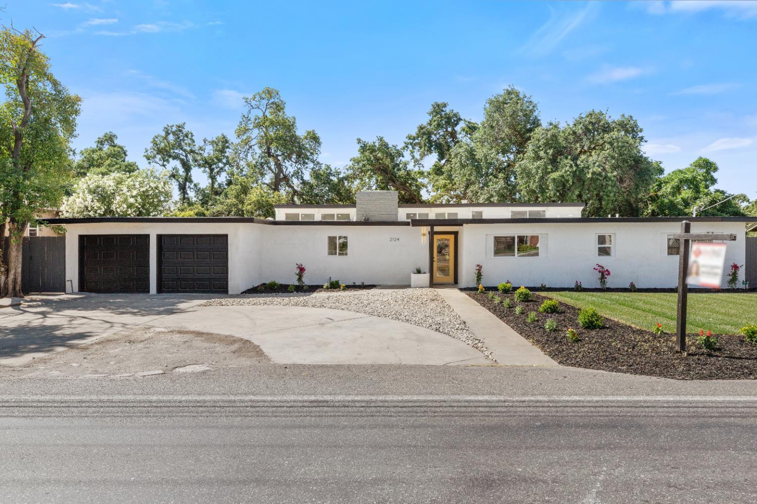 a view of a house with a yard and garage