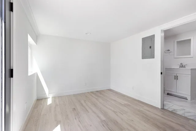 a view of empty room with wooden floor