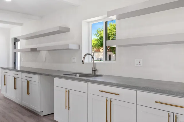 a kitchen with appliances cabinets and a window