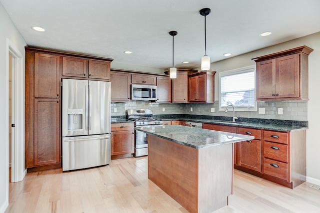 2003 Rylan Road Mahomet, IL 61853 - Photo 6 of 41 a kitchen with stainless steel appliances granite countertop a refrigerator a stove a sink and a microwave