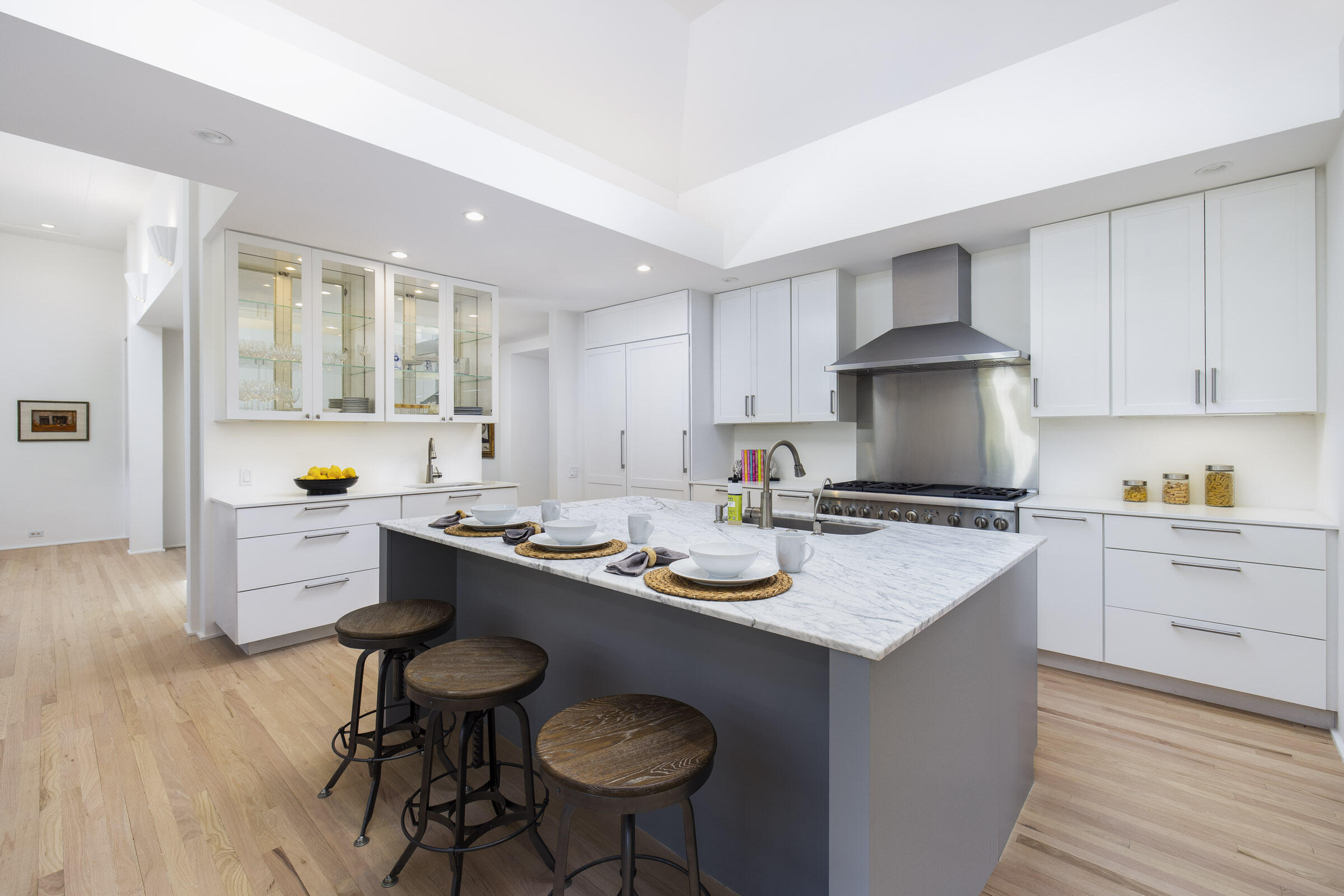 800 Hot Springs Road Montecito, CA 93108 - Photo 6 of 22 a kitchen with a sink stove and white cabinets with wooden floor
