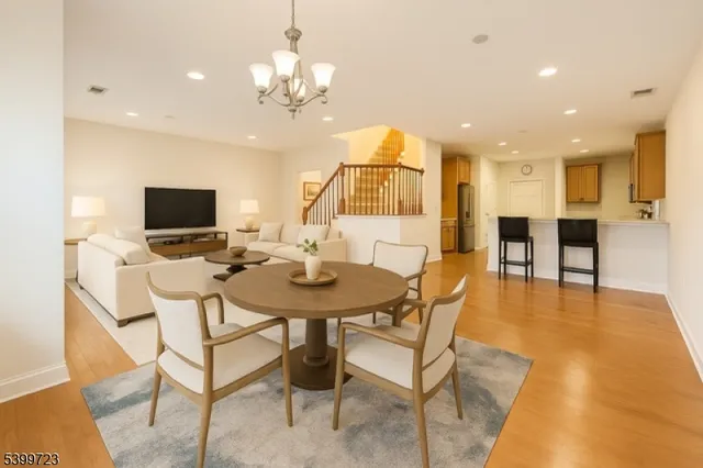 a view of a dining room with furniture and a flat screen tv