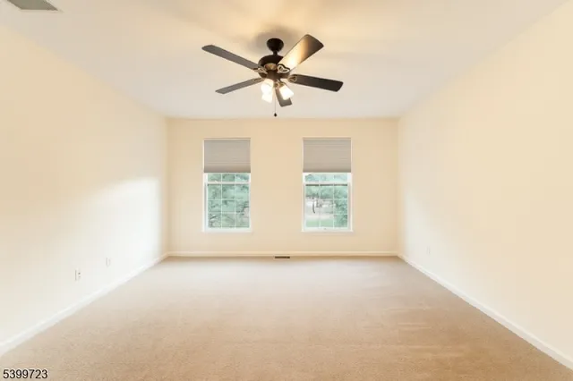 a view of room with window and ceiling fan