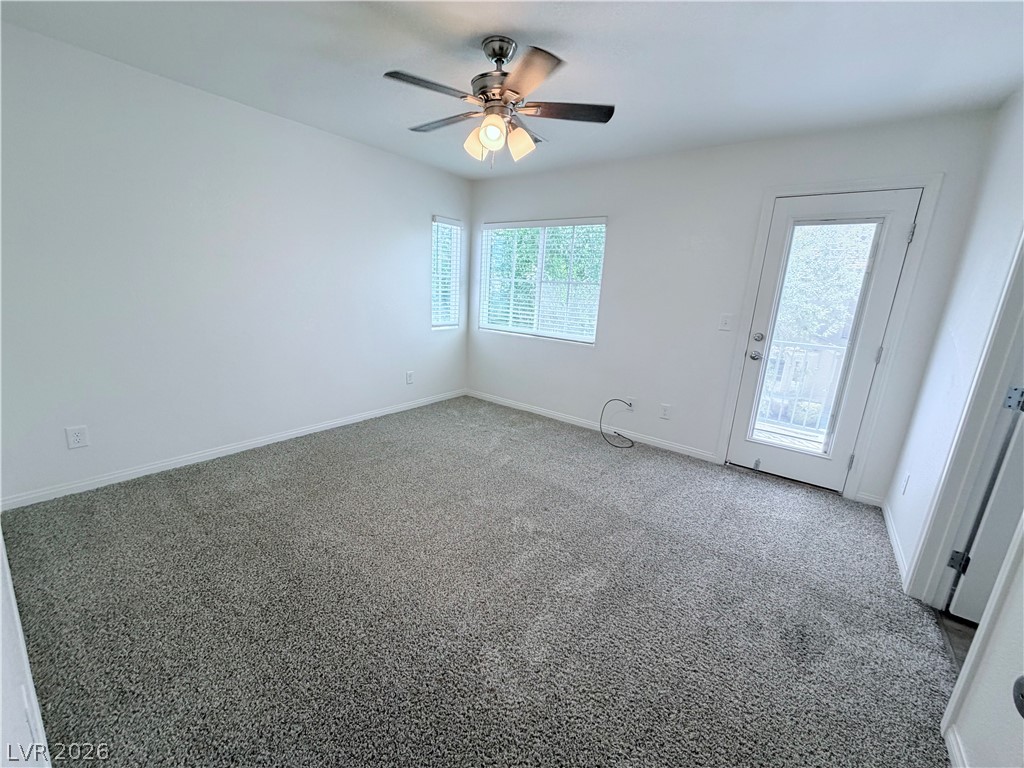 3610 Wireless Court Las Vegas, NV 89129 - Photo 9 of 15 A well-lit room with plush carpet flooring offers a private outdoor access.