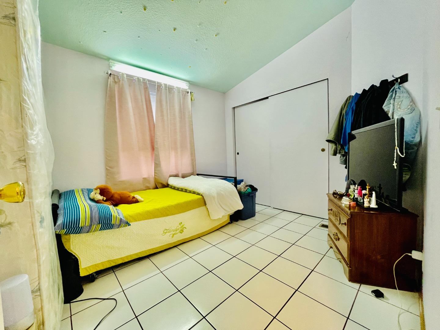 2600 Senter Road, Unit 261 San Jose, CA 95111 - Photo 7 of 12 a bedroom with a bed and teddy bear on bed